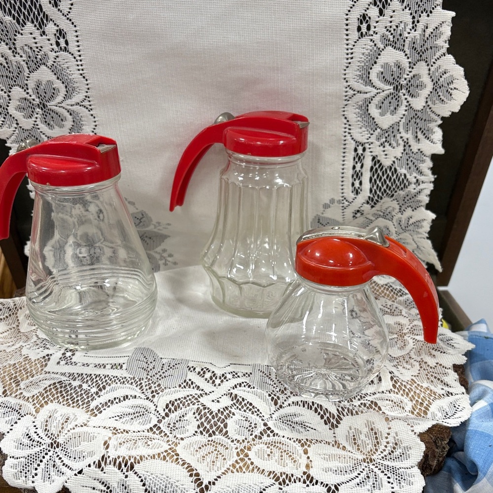 Set of Three Glass Syrup Dispensers with Red Lids